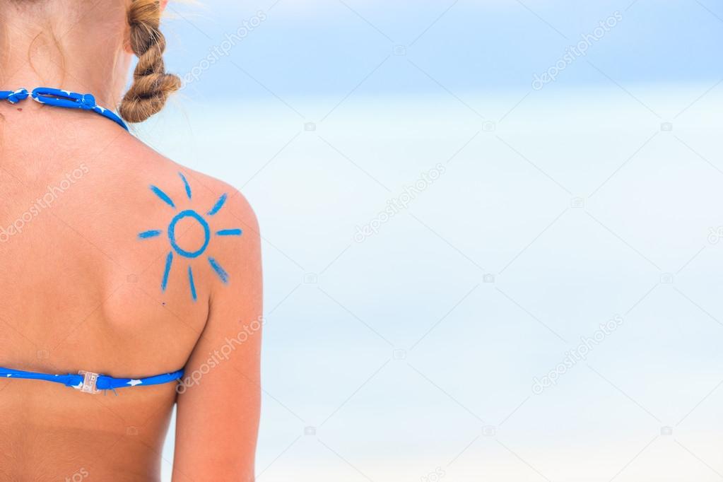 Close up sun painted by sun cream on kid shoulder