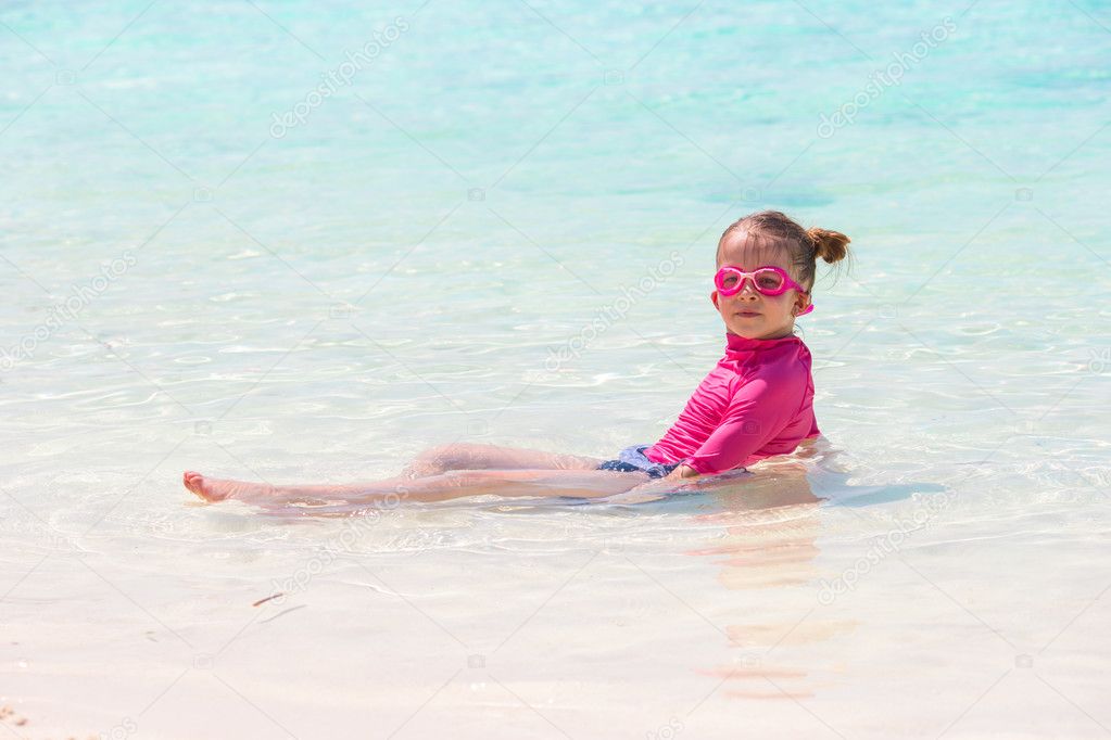 Adorable little girl at beach during summer vacation