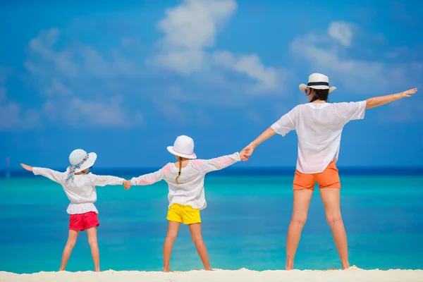 Happy family of three on tropical white beach — Stock Photo, Image