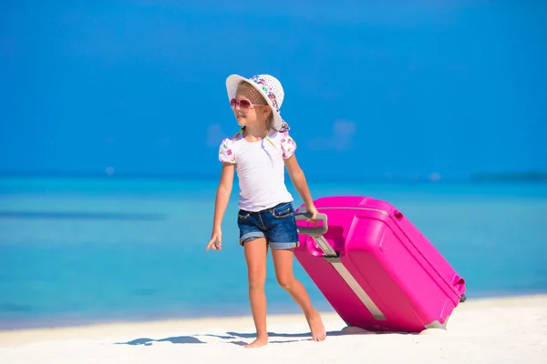 Little adorable girl with big bag on white beach — Stock Photo, Image