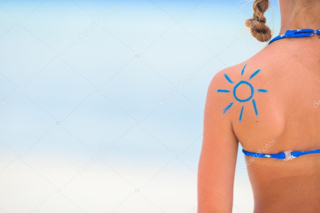 Close up sun painted by sun cream on kid shoulder