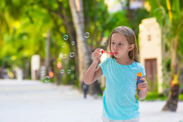 Adorable little girl making soap bubbles during summer vacation — Stock Photo, Image