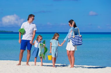 Sahilde tatilde olan dört kişilik bir aile.