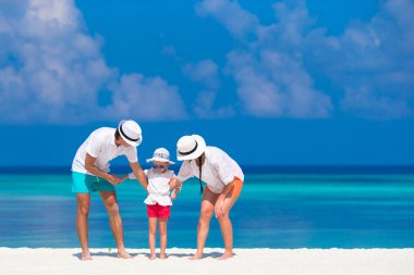 Üç beyaz plaj tropikal tatil sırasında genç aile