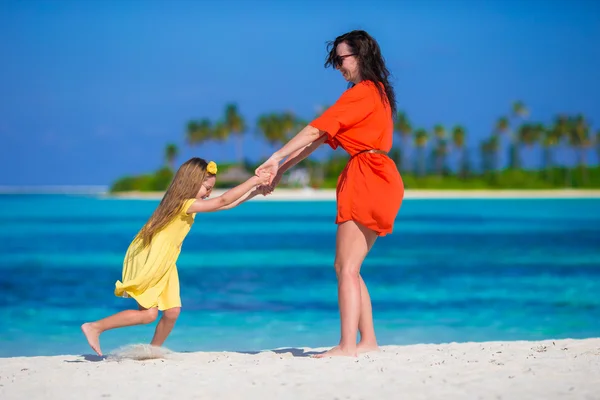 Niña y madre joven durante las vacaciones en la playa — Foto de Stock