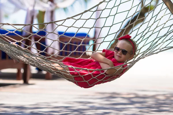 Roztomilá holčička na tropickou dovolenou v houpací síti — Stock fotografie