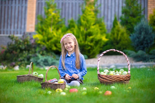 Little girl with baskets full of tomatoes — Stock Photo, Image