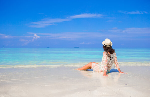 Young happy woman enjoy summer vacation on white sandy beach