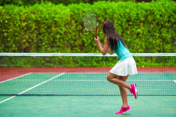 Junge aktive Frau spielt im Tropenurlaub Tennis — Stockfoto