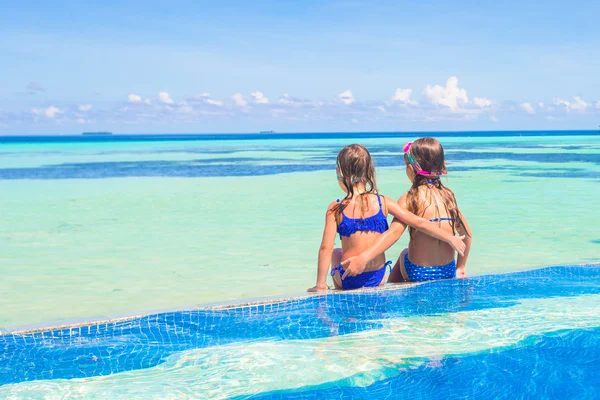 Adorable little girls in outdoor swimming pool — Stock Photo, Image