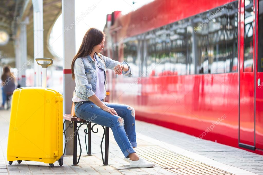 Young girl with luggage on the platform waiting for Aeroexpress