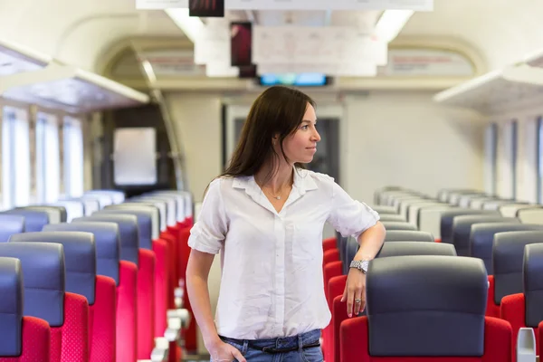 Young happy girl traveling by train — Stock Photo, Image