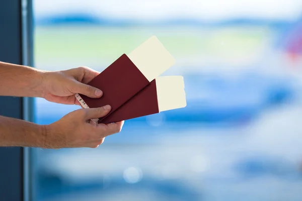 Pasaportes de primer plano y tarjeta de embarque en el aeropuerto avión de fondo interior —  Fotos de Stock