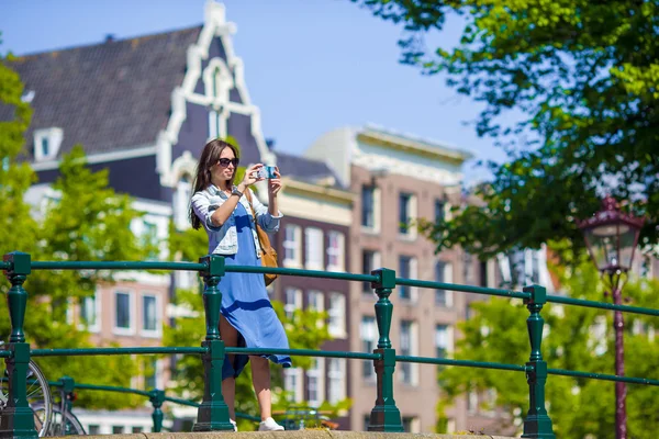 Young woman tourist taking photo on beautiful view of european city with mobile smart phone camera — Stock Photo, Image