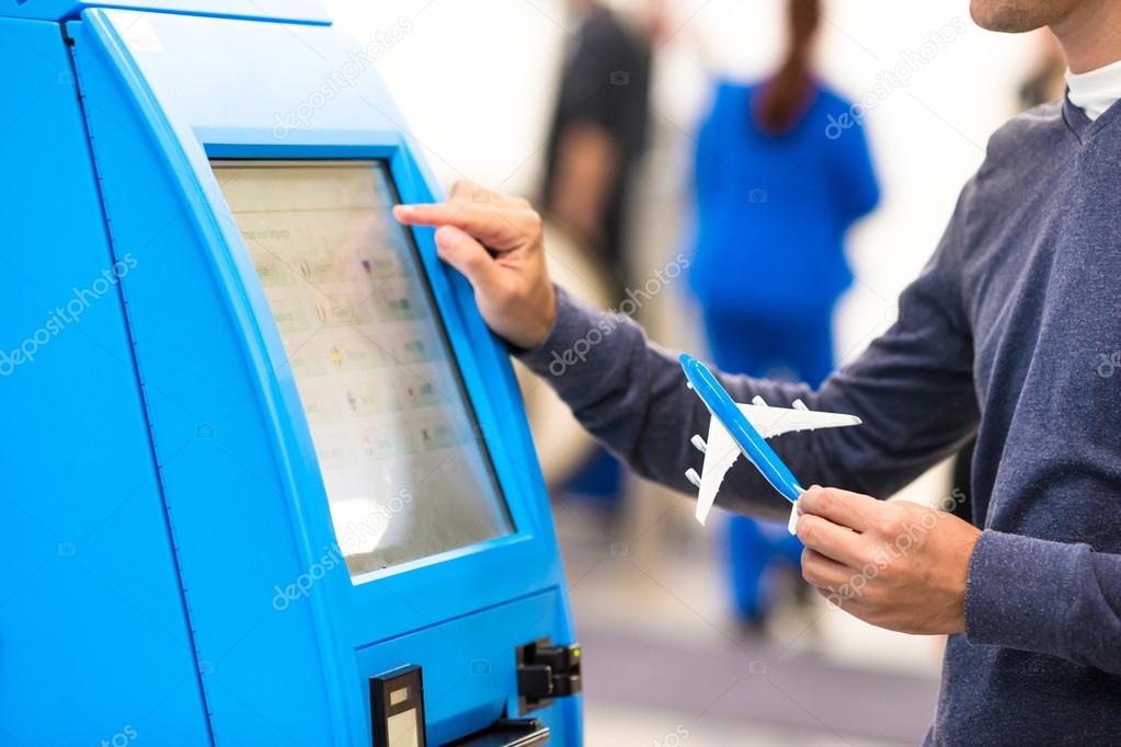 Close-up self-check-in for flight or buying airplane tickets at airport 