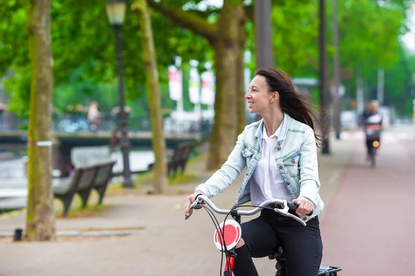 Young happy woman on bike in european city — Stock Photo, Image