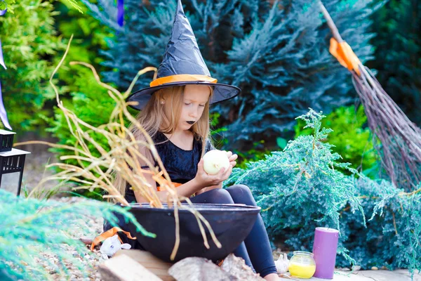 Happy little girl wearing witch costume on Halloween outdoors — Stock Photo, Image