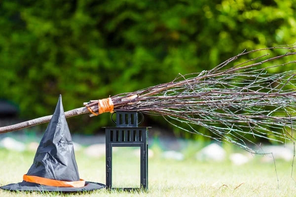 Halloween-Accessoires: Hut, Besen, Kerze, Knoblauch und Taschenlampen. — Stockfoto