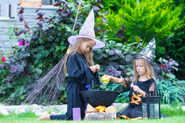 Adorable little girls in witch costume on Halloween have fun — Stock Photo, Image