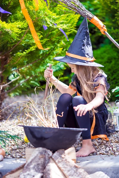 Cute little girl wearing witch costume on Halloween outdoors. Trick or treat. — Stock Photo, Image