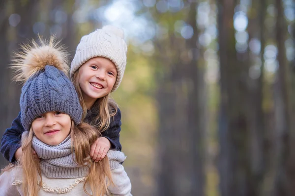 Little adorable girls at warm sunny autumn day in the forest — Stock Photo, Image