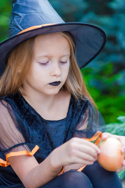 Adorable little girl wearing witch costume with broom on Halloween — Stock Photo, Image