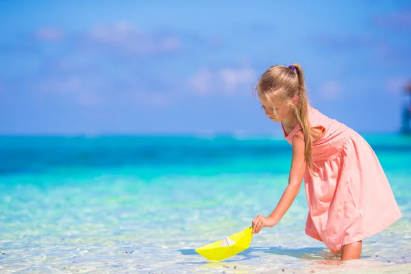 Sevimli kız sırasında tatil tropikal plaj oyuncakları ile oynarken — Stok fotoğraf