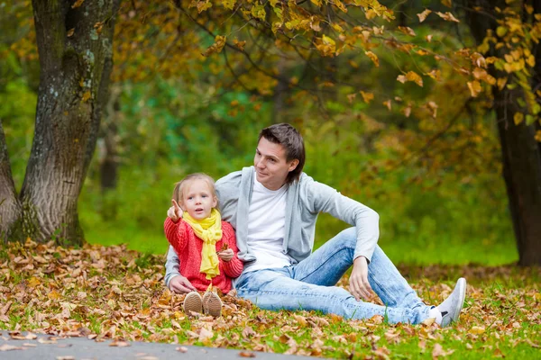 Little adorable girl with happy father in autumn park outdoors — Stock Photo, Image