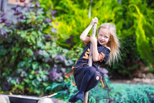 Adorable little girl wearing witch costume on Halloween at autumn day. Trick or treat. — Stock Photo, Image