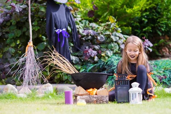 Happy little witch outdoors on Halloween. Trick or treat. — Stock Photo, Image