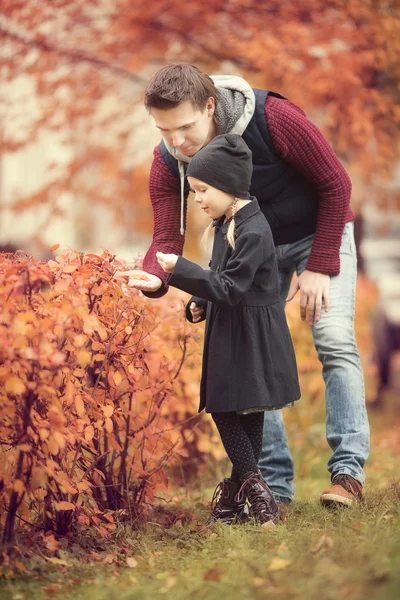 Little adorable girl with dad in autumn park at warm day — Stock Photo, Image