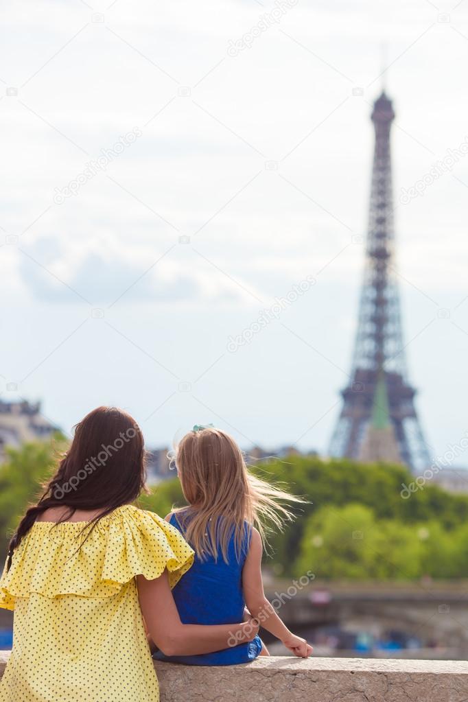 Happy mother and little adorable girl in Paris near Eiffel Tower during summer french vacation