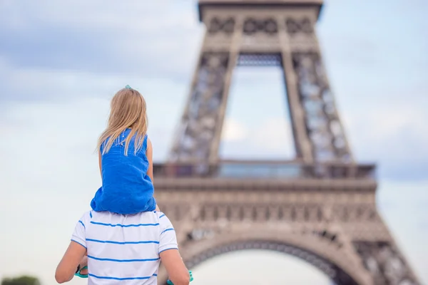 Beautiful happy family in Paris background Eiffel Tower. French summer holidays, travel and people concept.