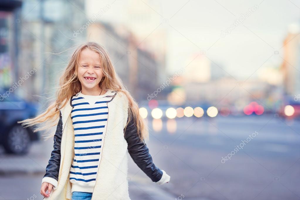 Adorable fashion little girl outdoors in European city