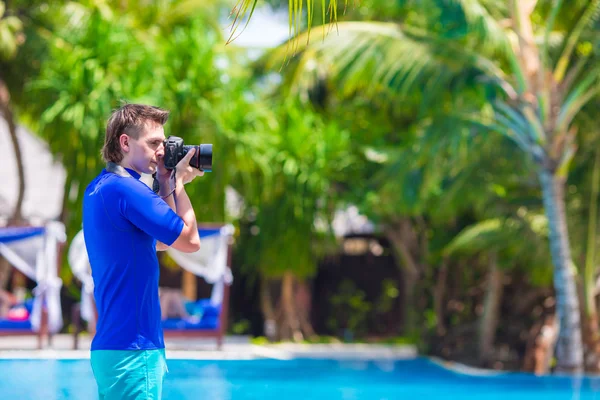 Jonge man fotograferen landschap op een tropisch eiland — Stockfoto