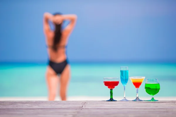 Exotic tasty cocktails in outdoor cafe background turquoise sea and girl — Stock Photo, Image