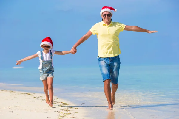Mutlu Noel Baba şapkaları ailesinde beach Noel tatili sırasında — Stok fotoğraf