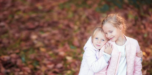Little adorable kids at warm day in autumn park outdoors — Stock Photo, Image