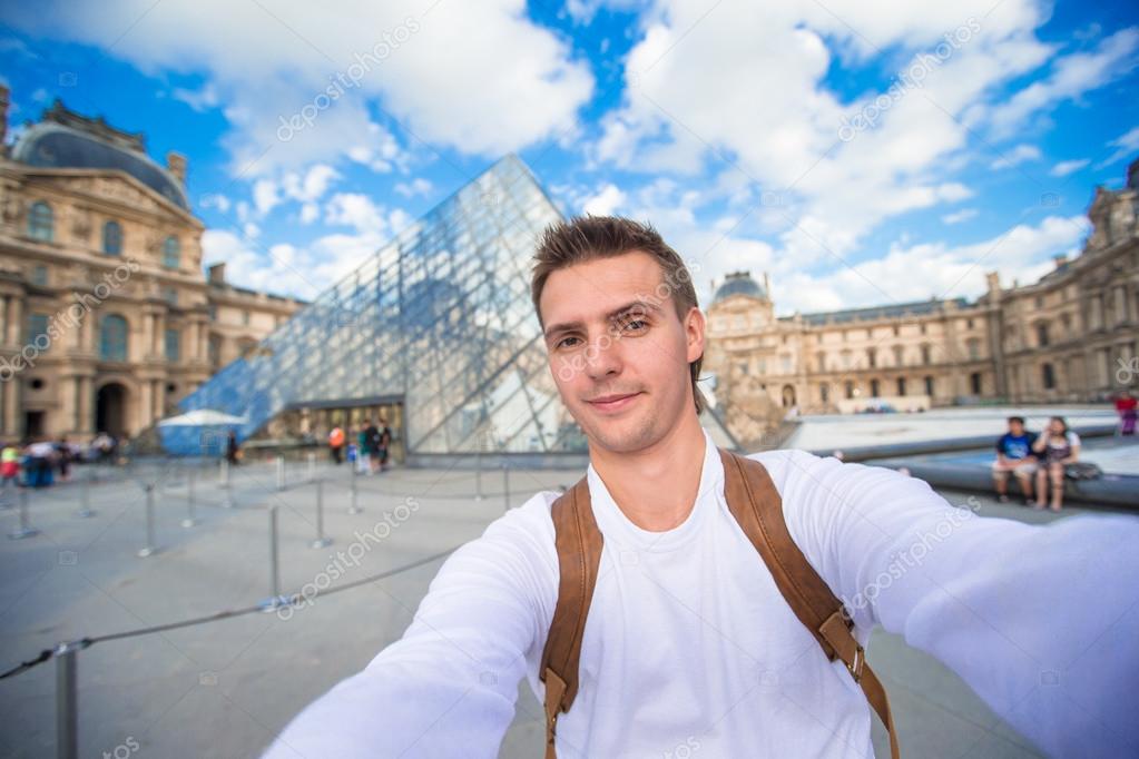 Happy young man taking a selfie photo in Paris, France