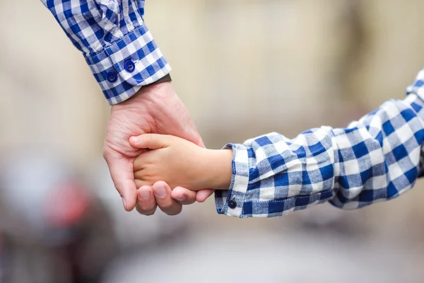 Family together hand by hand on street at european city — Stock Photo, Image