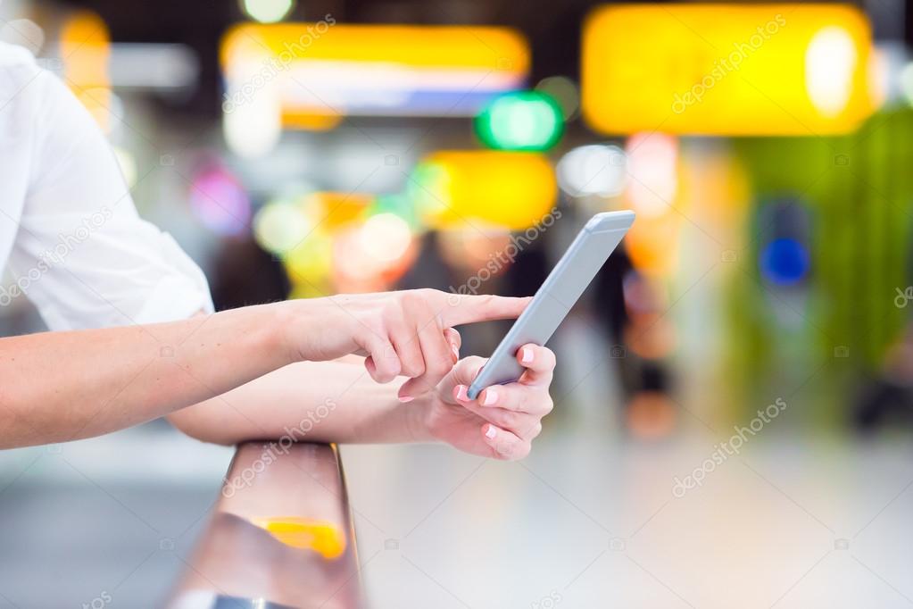 Closeup cell phone at airport in female hands