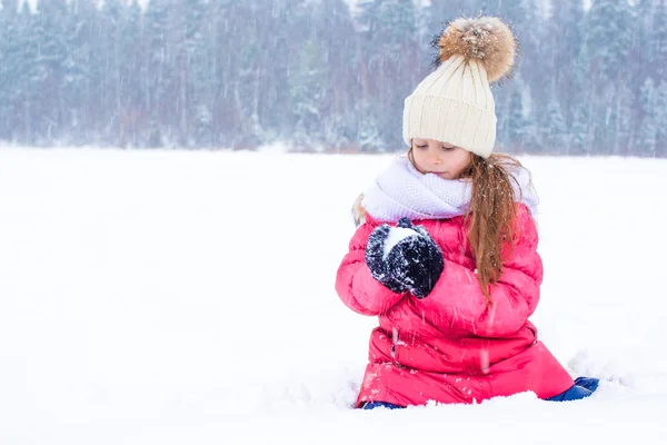 Little adorable girl in snow sunny winter day outdoors — Stock Photo, Image