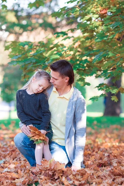 Happy family in autumn park at warm day — Stock Photo, Image