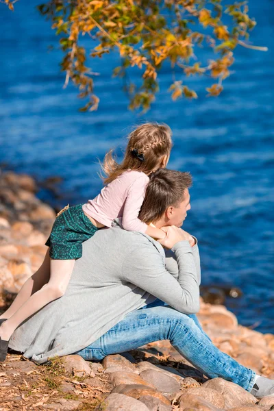 Happy family in autumn park at warm day — Stock Photo, Image