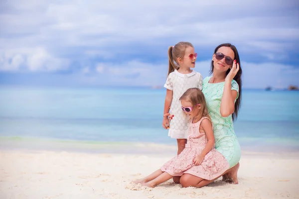 Adorable little girls and young mother on tropical white beach — Stock Photo, Image