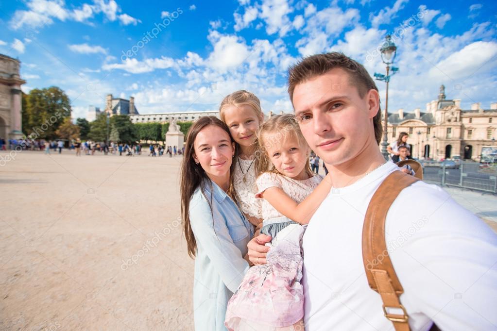 Family with two kids taking selfie in Paris outdoors