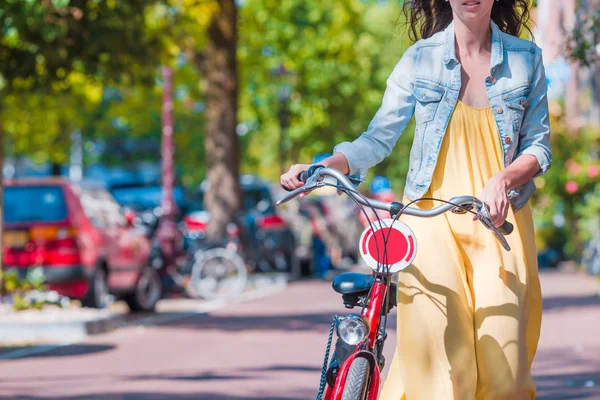 Young happy woman on bike in european city — Stock Photo, Image