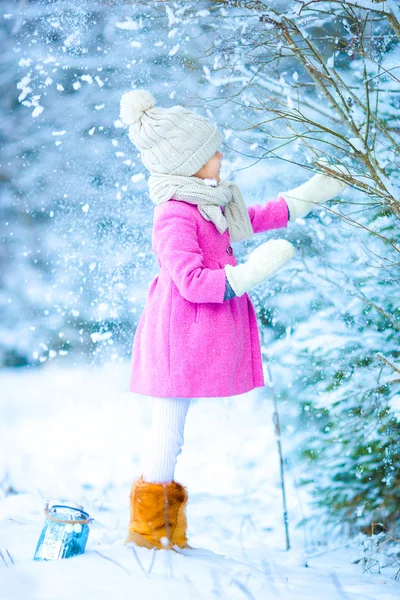 Meisje met zaklamp en de kaars in de winter op kerstavond buitenshuis — Stockfoto