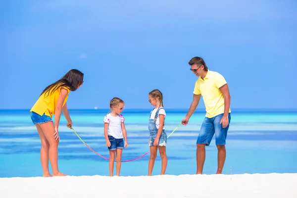 Happy family playing on white tropical beach — Stock Photo, Image