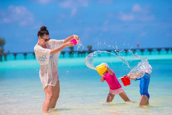Famiglia felice che gioca con i giocattoli sulla spiaggia in vacanza tropicale — Foto Stock